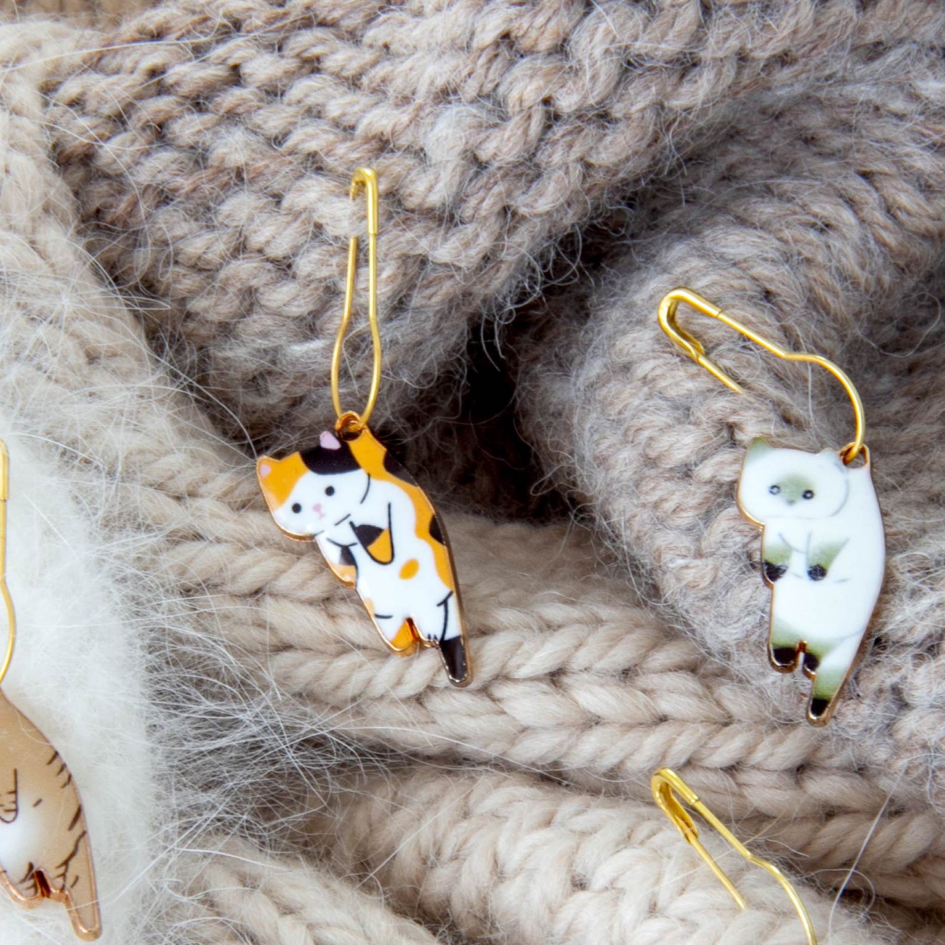 Whimsical Cat Stitch Markers for Crocheters – Cat-themed enamel stitch markers on gold pins for knitting and crochet projects.