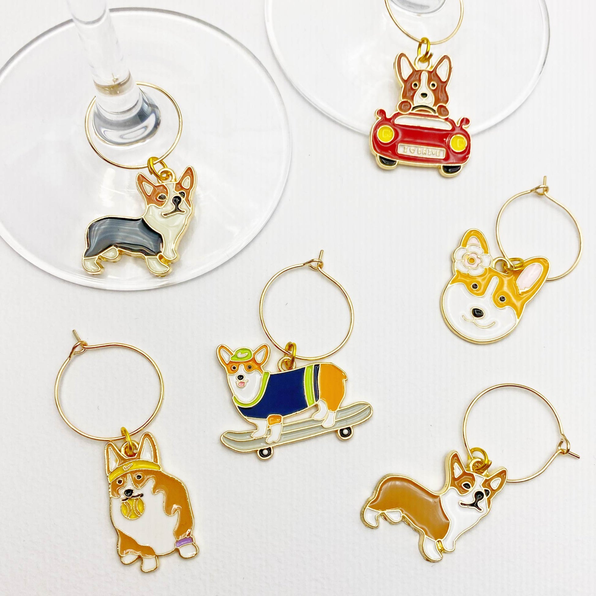 Dog-Themed Wine Glass Markers – Adorable enamel charms of corgis in a variety of poses for marking wine glasses at parties.