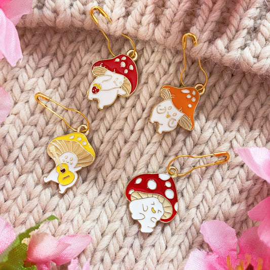 Happy Mushroom Stitch Markers Set – Whimsical stitch markers with cheerful mushroom designs for knitting and crochet.